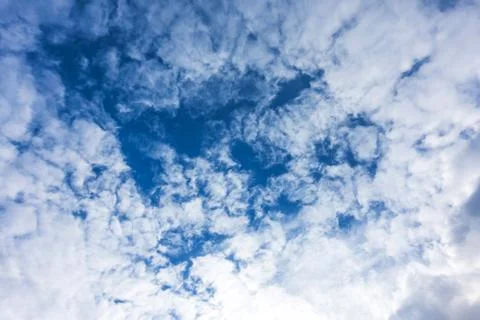 Blue sky with white clouds under sunshine Stock Photos