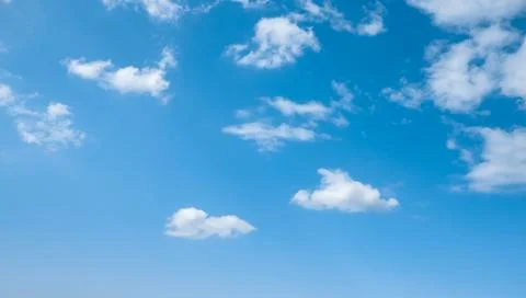 Blue sky with white clouds. Wispy Clouds in Blue Sky. Cloudscape - Blue sky.. Stock Photos