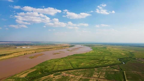 Blue Sky - White Clouds - Yellow River - River Beach Stock Footage 258091739