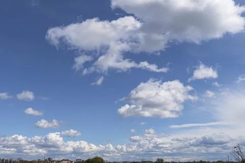 Blue Sky with White Cumulus Clouds Over Scenic Landscape Stock Photos