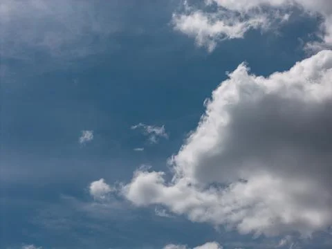 Blue sky with white cumulus clouds on a clear day Фото