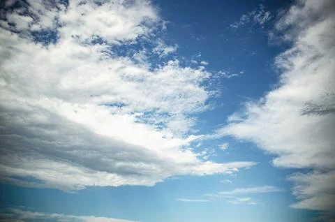 Blue sky with white cumulus clouds creating weather background Stock Photos