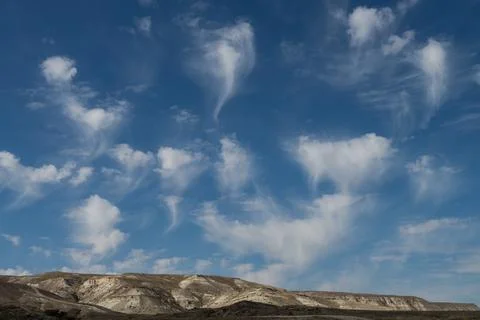 Blue sky with white feather-like clouds Stock Photos