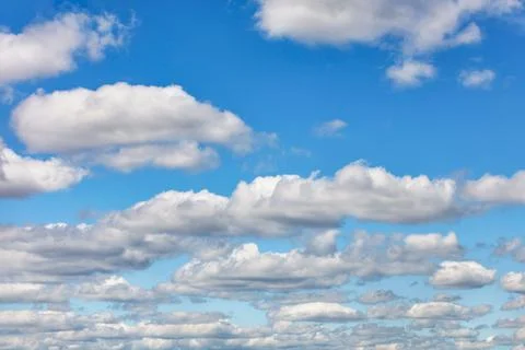 Blue sky with white floating clouds at daytime. Stock Photos