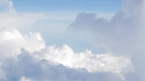 Blue sky with white fluffy clouds from airplane flight fly over the clouds .. Stock Footage 312351162
