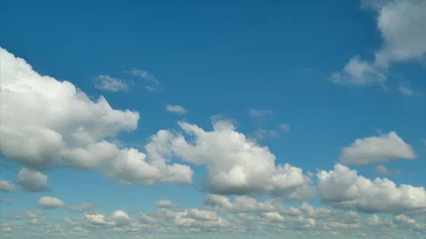 Blue sky with white fluffy clouds. Natural outdoor background with bright sunny Stock Footage 342276862