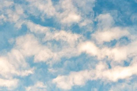 Blue sky with white fluffy clouds on a bright sunny day Stock Photos