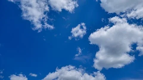 Blue Sky With White Fluffy Clouds Stock Photos