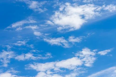 Blue sky with white fluffy clouds on a sunny day Stock Photos