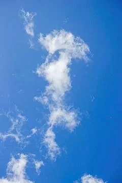 Blue sky with white fluffy clouds on a clear day Stock Photos