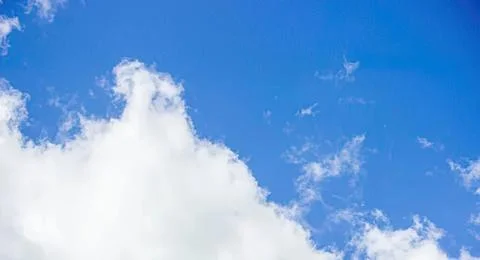 Blue sky with white fluffy clouds on a sunny day Stock Photos