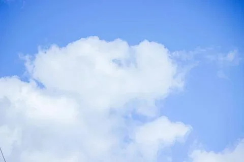 Blue sky with white fluffy clouds on a sunny day Stock Photos