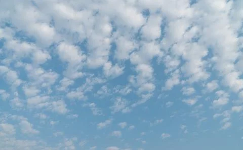 Blue sky with white patchy clouds Stock Photos