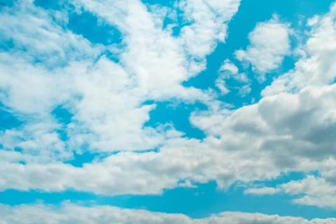 Blue sky with white soft clouds on sunny day. Stock Photos