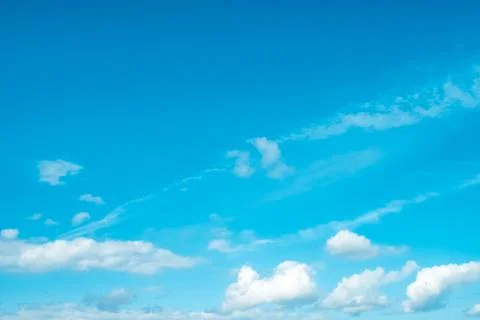 Blue sky with white soft clouds on sunny day. Stock Photos