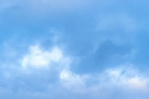 Blue sky with white, soft clouds. Nature background. Stock Photos