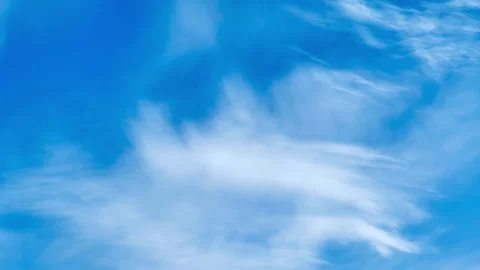 Blue sky with white wispy cirrus clouds. Natural background showing soft cloud Stock Footage 344906683
