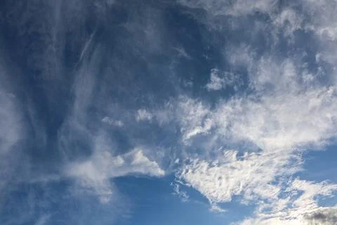 Blue sky with white wispy clouds floating in atmosphere Photos