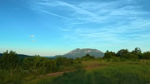 Blue sky with wispy clouds above green hills. Mount Rtanj Area, Serbia Stock Footage 340898786