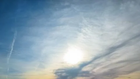 Blue Sky with Wispy Clouds and Soft Evening Light Stock Photos