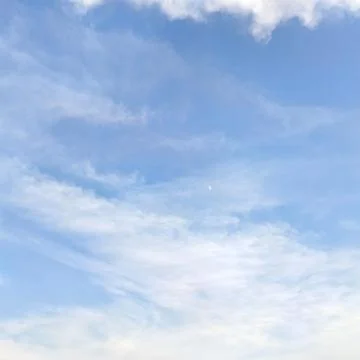 Blue sky with wispy clouds Stock Photos