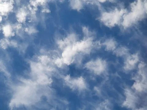 Blue Sky With Wispy White Clouds Overhead Serene Airy Background For Design.. Fotos de archivo