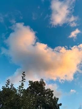 Blue sky with yellow clouds Stock Photos