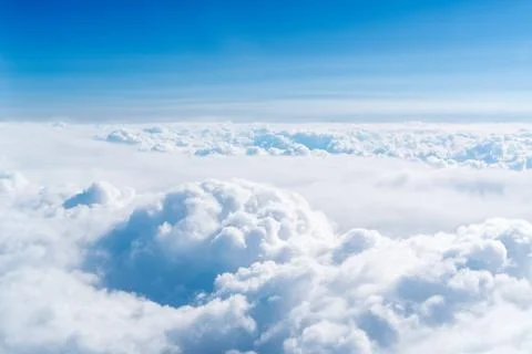Blue skyline and cloudscape, view of the airplane window Stock Photos
