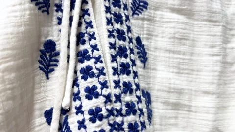 Blue Slavic national pattern with flower on white linen cotton clothes Stock Footage 308562517