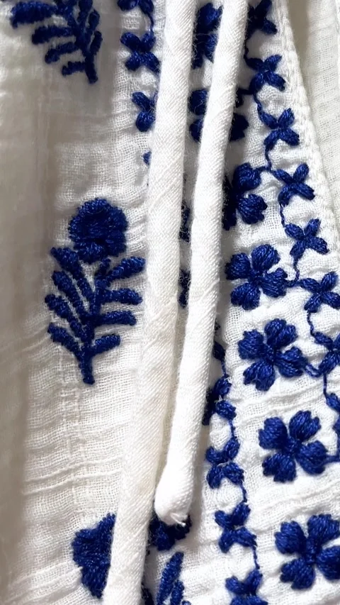 Blue Slavic national pattern with flower on white linen cotton dress Stock Footage 312513171