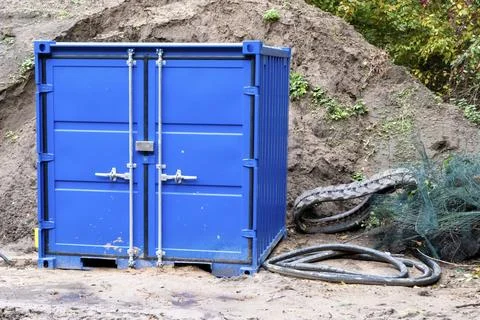 Blue small container on a construction site Stock Photos