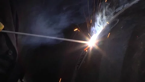 Blue smoke and yellow-red sparks fly from the electrode in all sides Video stock 129133798