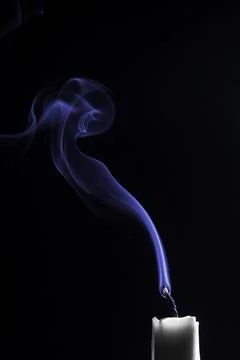 Blue smoke emanating from a freshly extinguished candle Stock Photos