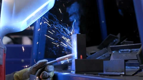 Blue smoke flashes from burning of metallic materials closeup. Male person worki Stock Footage 199475172