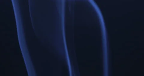 Blue smoke floating through space against black background Stock Footage 140687376