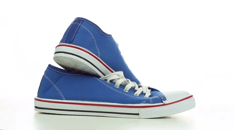 Blue sneakers revolve on a white background Video stock 49671619