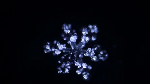 Blue snowflake melts in the dark Stock Footage 72767721