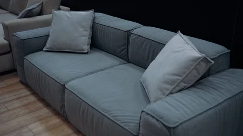 Blue sofa with gray cushions, slow shot from above. 4k video. Video stock 231688923
