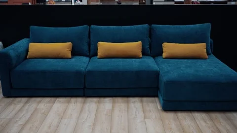 Blue sofa, with yellow decorative pillows, set up in the office. 4k video Stock Footage 231507846