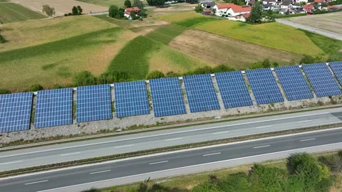 Blue Solar panel farm installed on the slopes of a highway. Stock Footage 208397321