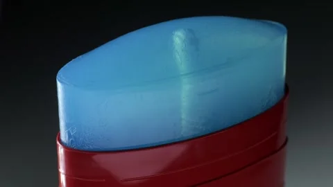 This is a Blue Solid Stick Deodorant packaged in a vibrant Red Container for Stock Footage 306065670