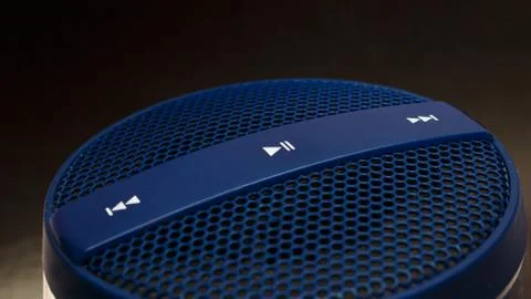 Blue speaker with control buttons on dark background Foto stock