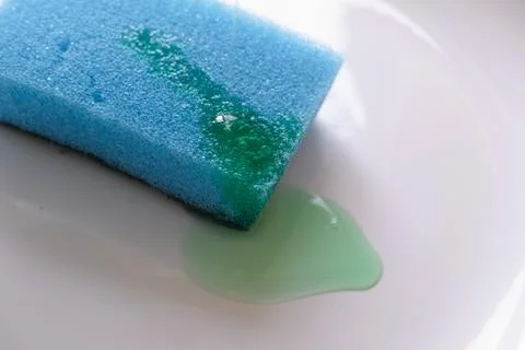 Blue sponge with detergent in a plate Stock Photos