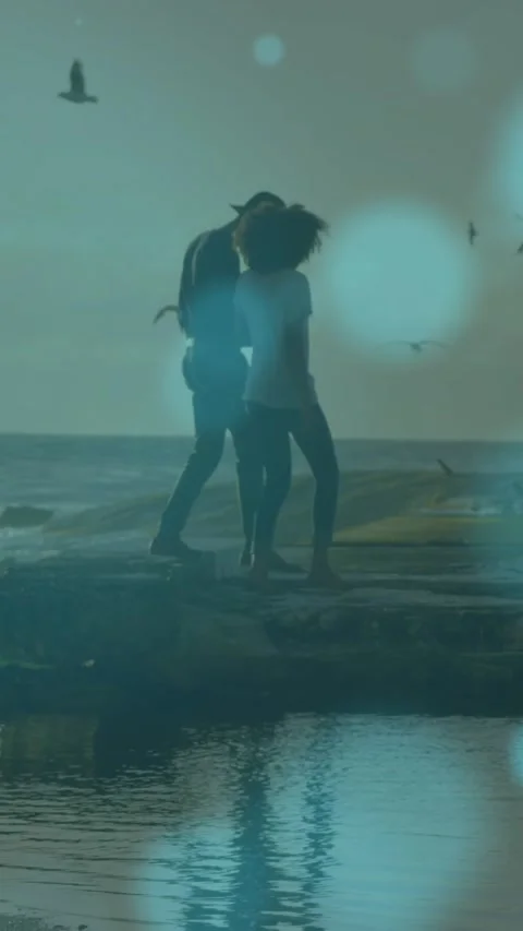 Blue spots of light floating against african american couple walking on the Видео 343083766
