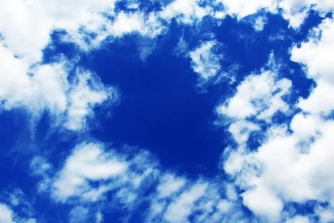 Blue spring sky dotted with many bizarre clouds Stock Photos