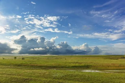 Blue spring sky with heavy clouds over the wet fields Stock-Fotos