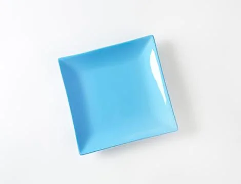 Blue square plastic bowl on surface Stock Photos