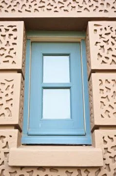 Blue square window in brown wall at grand palace Stock Photos