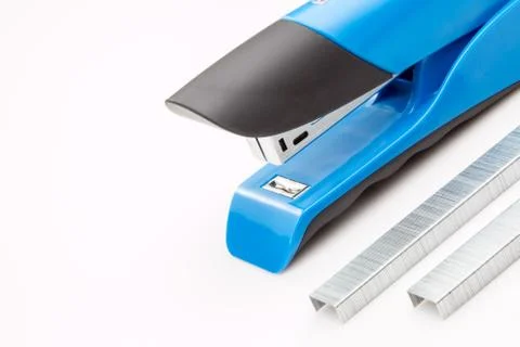 Blue stapler with staples on a white background. Stock Photos