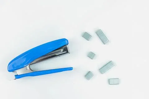 Blue stapler with staples on white background Stock Photos